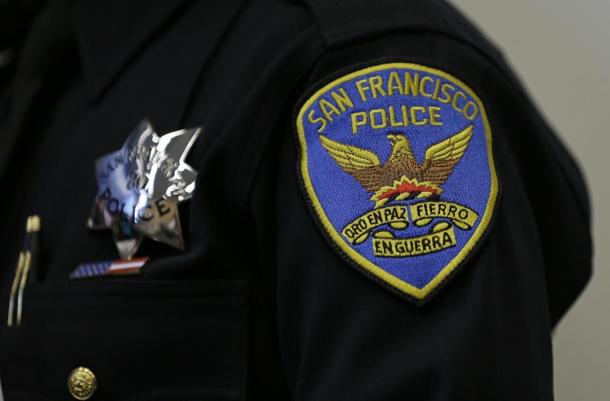 A patch and badge on the uniform of a San Francisco police officer