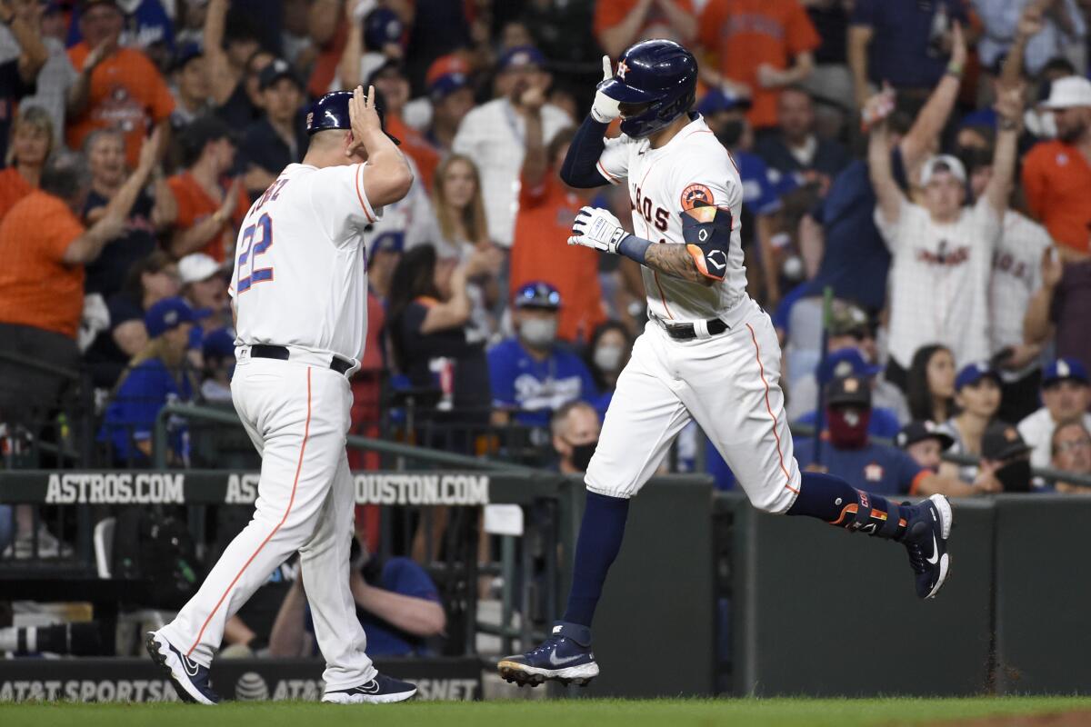 Houston Astros' Carlos Correa rounds the bases after hitting a solo home run.