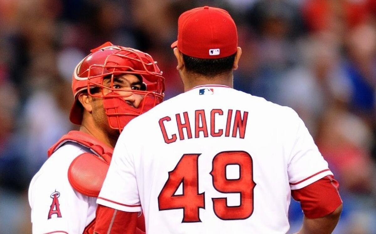 Angels pitcher Jhoulys Chacin (49) talks with catcher Carlos Perez during a game on May 19 at Angel Stadium
