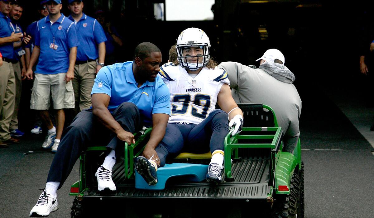 Chargers running back Danny Woodhead is taken off the field on a car after breaking his lower right leg in a game against the Bills on Sunday in Buffalo.