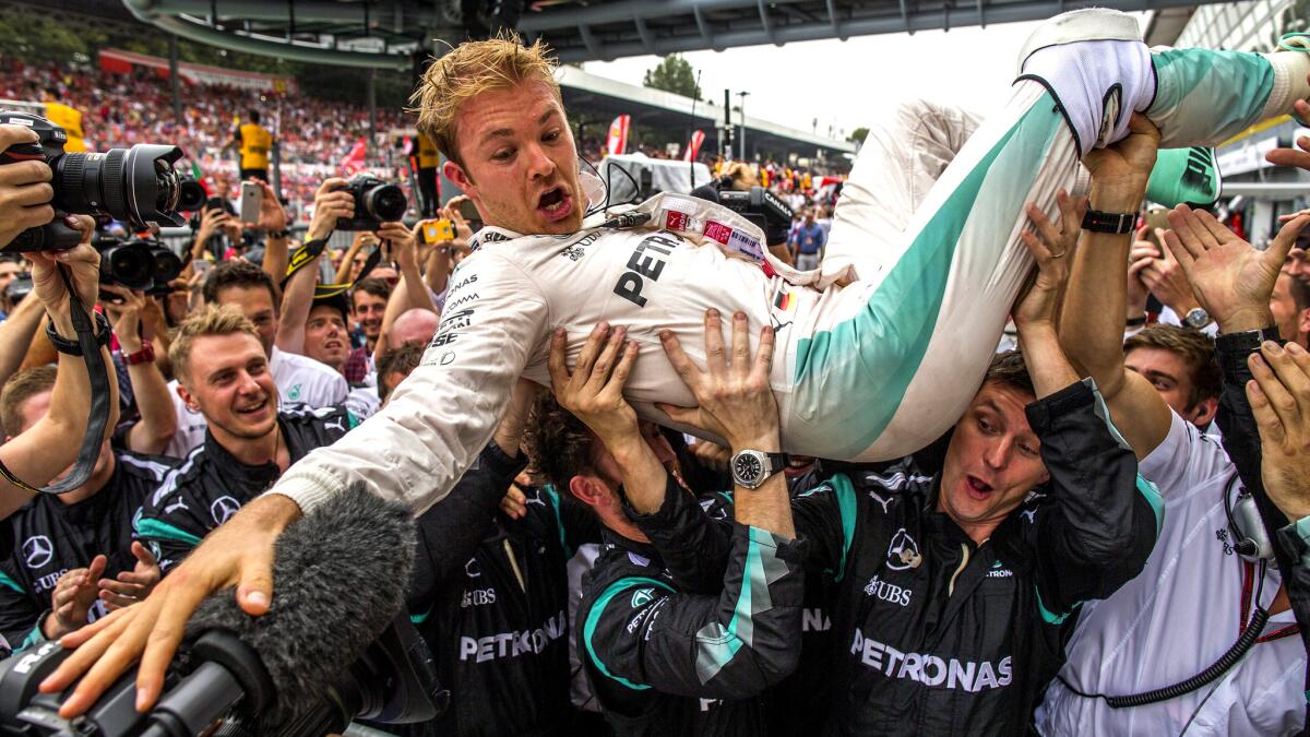 Formula One driver Nico Rosberg celebrates with his team members after winning the Italian Grand Prix on Sunday.