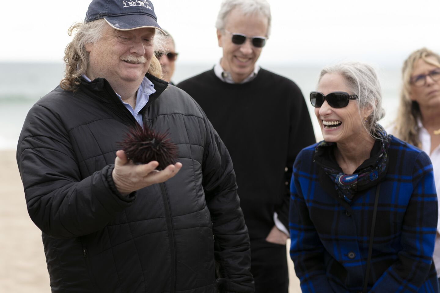 Los Angeles Times food critic Jonathan Gold handles a sea urchin during a Food Bowl event in Manhattan Beach in May.