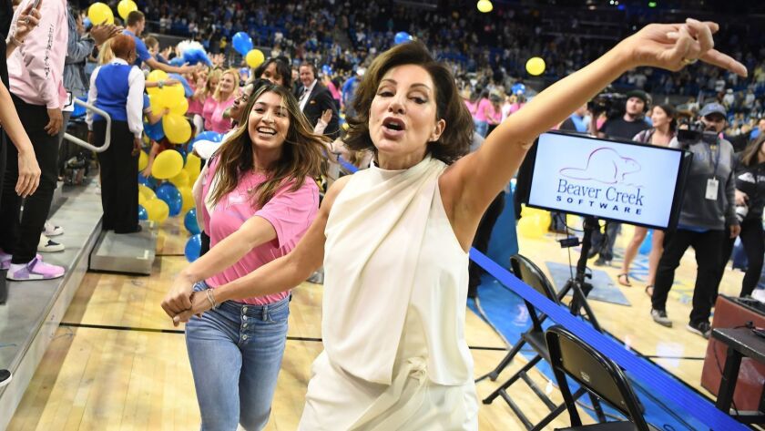 UCLA gymnastics coach Valorie Kondos Field leads former Bruins gymnasts around Pauley Pavilion while dancing during her retirement ceremony in March.