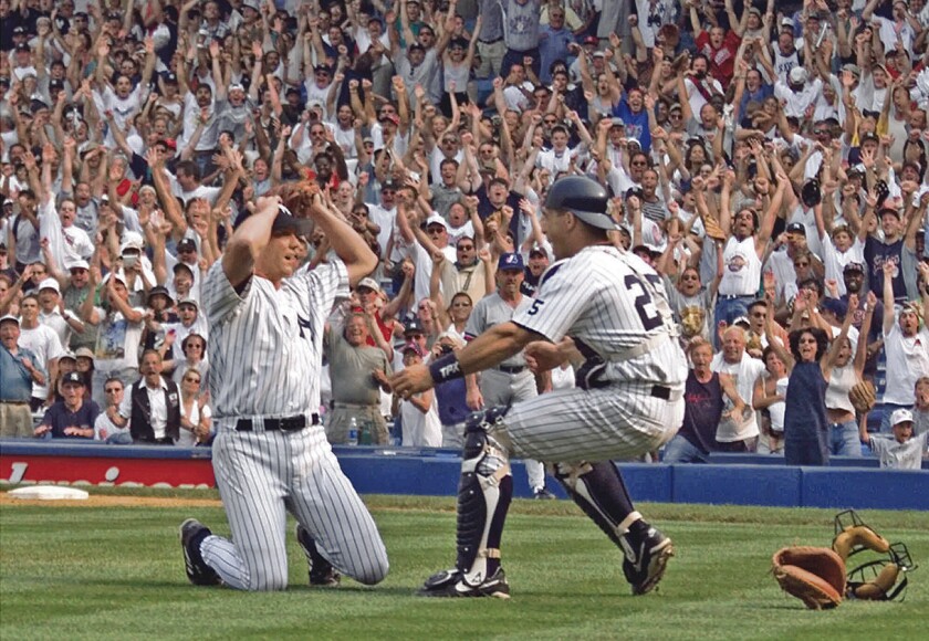 New York Yankees pitcher David Cone is congratulated by catcher Joe Girardi after Cone pitched a perfect game against the Montreal Expos on Sunday, July 18, 1999.