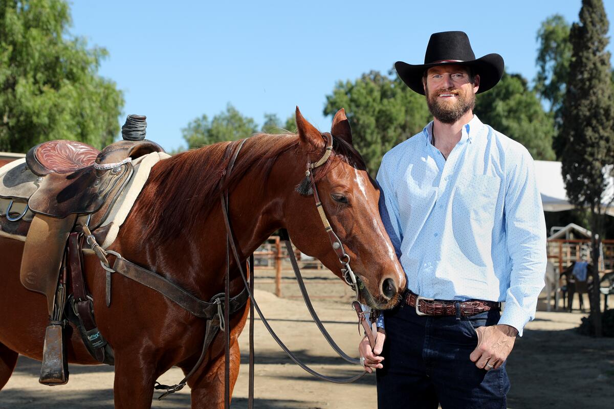 Dan Almquist stands with his horse Sailor at Ortega Equestrian Center in San Juan Capistrano. 