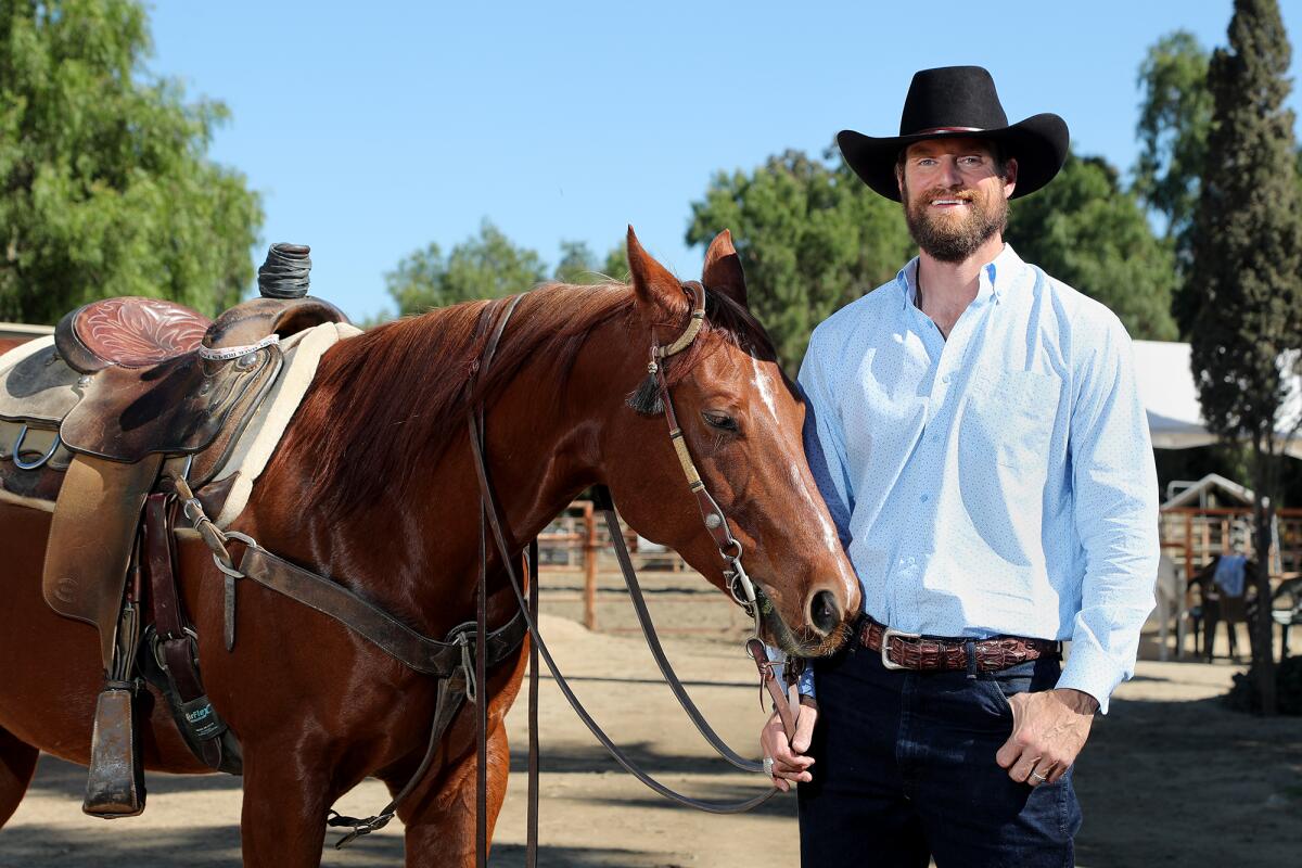 Dan Almquist stands with his horse Sailor at Ortega Equestrian Center in San Juan Capistrano.