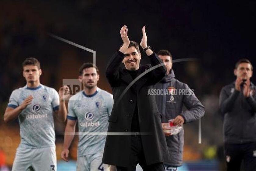 Bournemouth manager Andoni Iraola,front, applauds after the English Premier League soccer match between Wolverhampton Wanderers and Bournemouth in Wolverhampton, England, Wednesday, April 24, 2024. ( Joe Giddens/PA via AP)