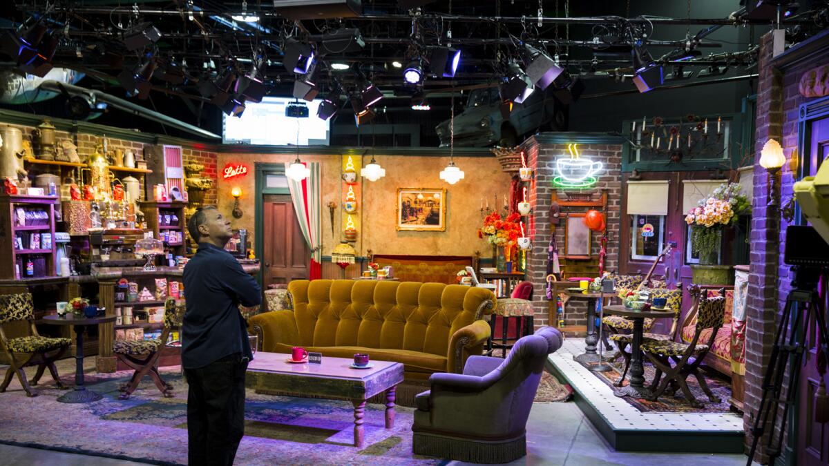 A worker looks over the "Central Perk" coffee shop set used on the program "Friends." The set is part of Stage 48, a new interactive section of the backlot tour at Warner Bros. Studio in Burbank.
