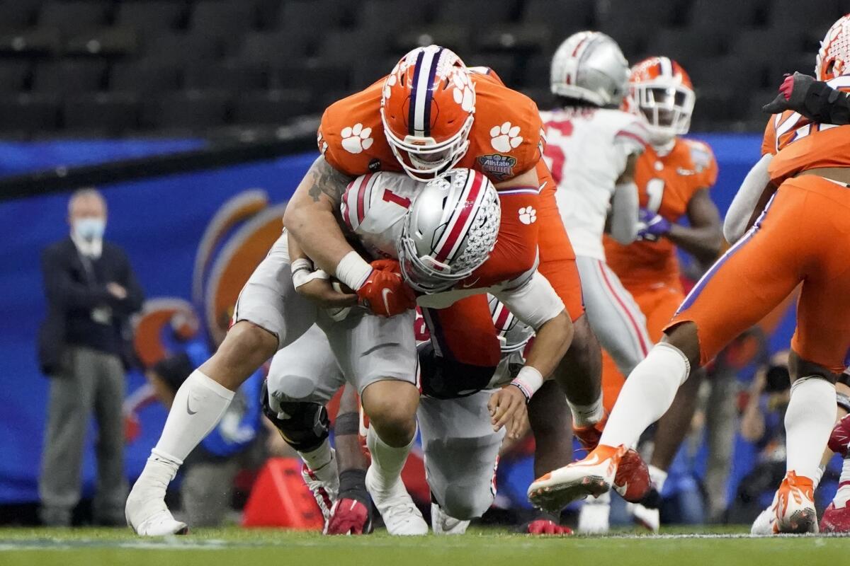 FILE - Ohio State quarterback Justin Fields is sacked by Clemson defensive lineman Bryan Bresee during the second half of the Sugar Bowl NCAA college football game in New Orleans, Jan. 1, 2021. Bresee was named to the Associated Press preseason All-America team, Monday, Aug. 22, 2022. (AP Photo/Gerald Herbert, File)