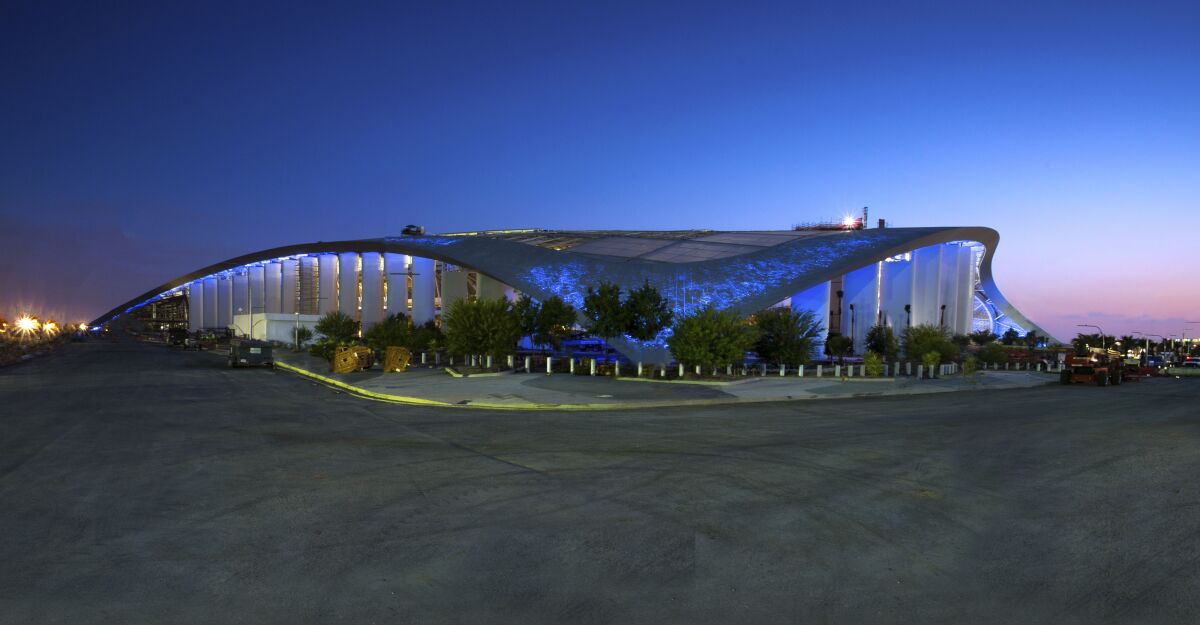 The fritted roof allows for SoFi Stadium to glow different hues at night.