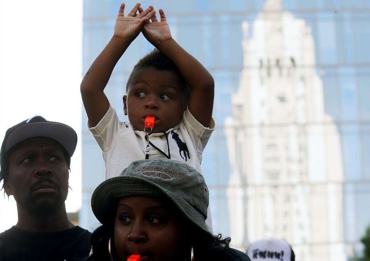 Nye Woods, seen here in a 2014 file photo, holds his hands up during a protest against police brutality. Long Beach police will pay nearly $3 million to the family of his father, Tyler Woods, under the terms of a settlement and separate verdict.