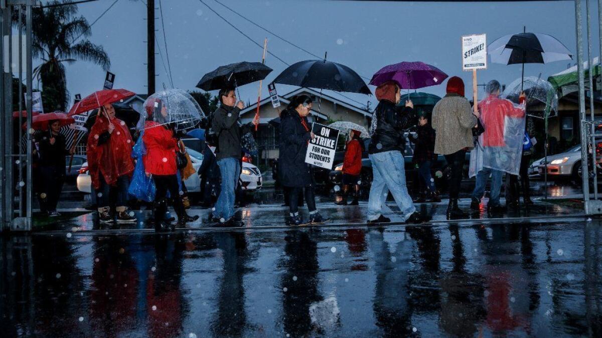 Educators and their supporters participate in the UTLA teachers' strike outside of Roosevelt High School in Los Angeles on Monday.