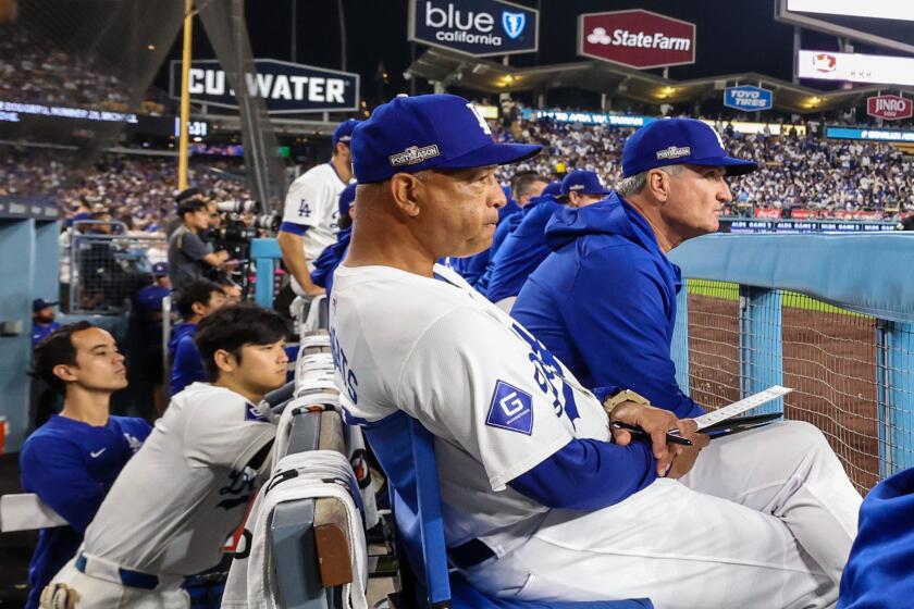 Los Angeles, CA, Sunday, October 6, 2024 - Dodgers manager Dave Roberts looks on from the dugout during a game against the San Diego Padres in game two of the National League Division Series at Dodger Stadium. (Robert Gauthier/Los Angeles Times)