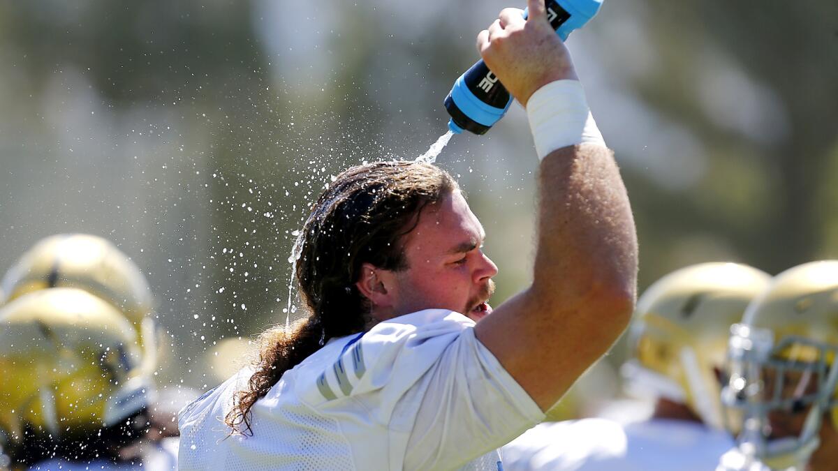 Offensive lineman Zach Bateman tries to cool off during the Bruins' workout on Monday in San Bernardino.