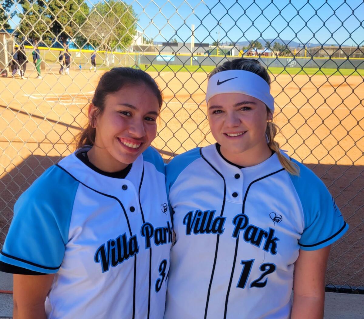 Freshman pitcher Auddrey Lira, left, with Gatorade player of the year Sydney Somerndike of Villa Park.