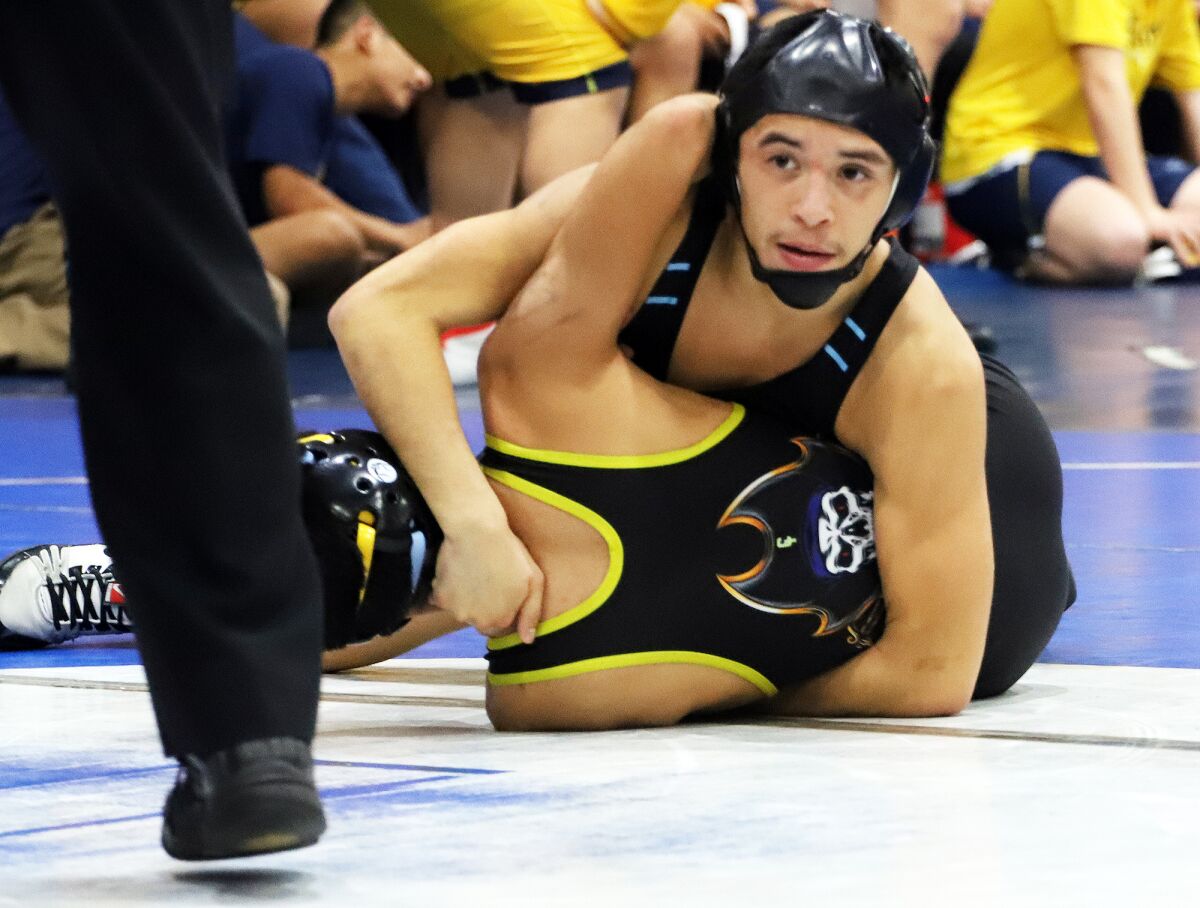 Marina's Adrian Jimenez tries to pin Channel Islands' Alex Torres in the 113-pound match in the CIF Division 5 Duals.
