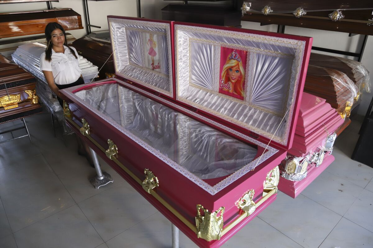 Ataúdes de color rosa con imágenes de la muñeca Barbie expuestos en una funeraria en Ahuachapán, 