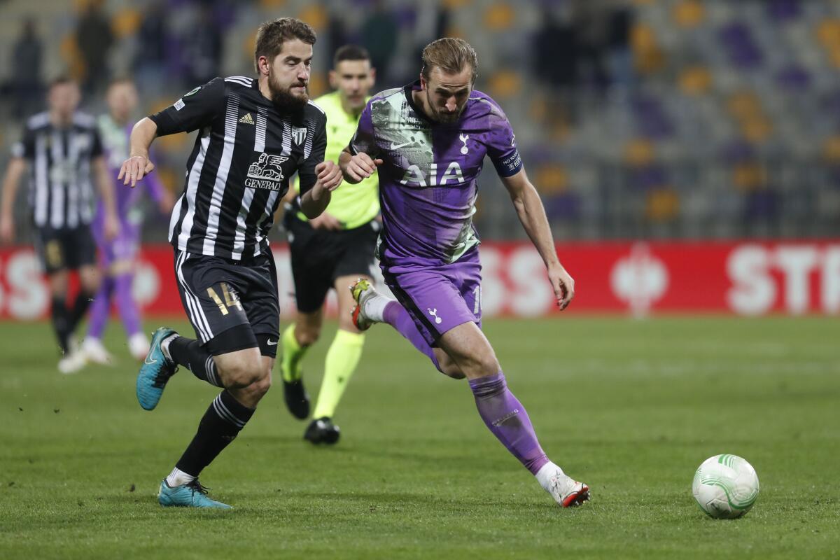 Mura's Nik Lorbek, left, is challenged by Tottenham's Harry Kane during the Europa Conference League match between Mura and Tottenham Hotspur in Maribor, Slovenia, Thursday, Nov. 25, 2021. (AP Photo)