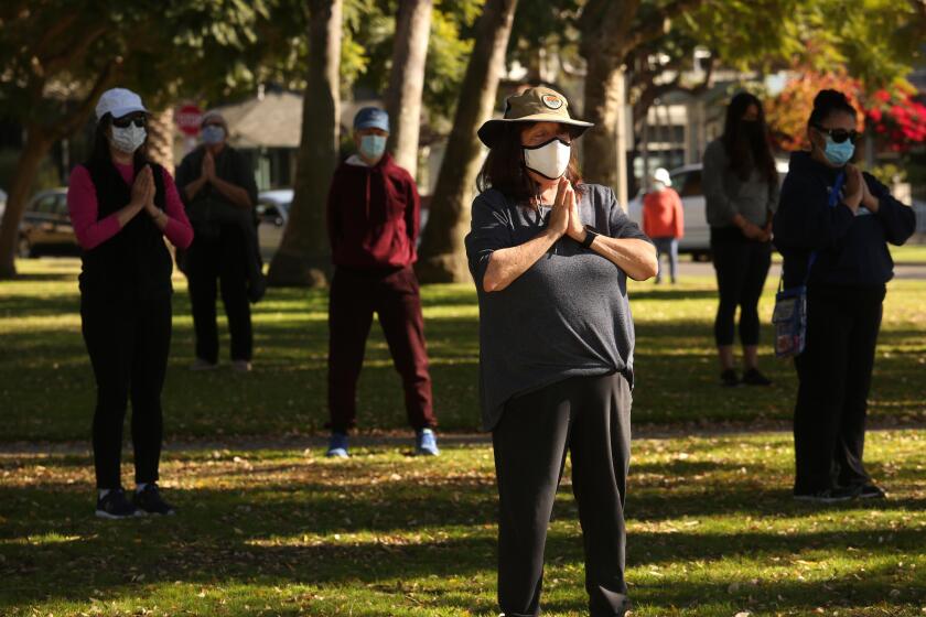CULVER CITY, CA - NOVEMBER 29, 2020 - People participate in a weekly Tai Chi class under the instruction of Angie Sierra in Dr. Paul Carlson Memorial Park in Culver City on Sunday, November 29, 2020. Sierra has been teaching Tai Chi in the park for the past 7 years. "Our classes did get smaller," Sierra said about the impact the coronavirus pandemic has had on attendance. Los Angeles County announced a new stay-home order Friday as coronavirus cases surged out of control in the nation's most populous county, banning most gatherings but stopping short of a full shutdown on retail stores and other non-essential businesses. (Genaro Molina / Los Angeles Times)