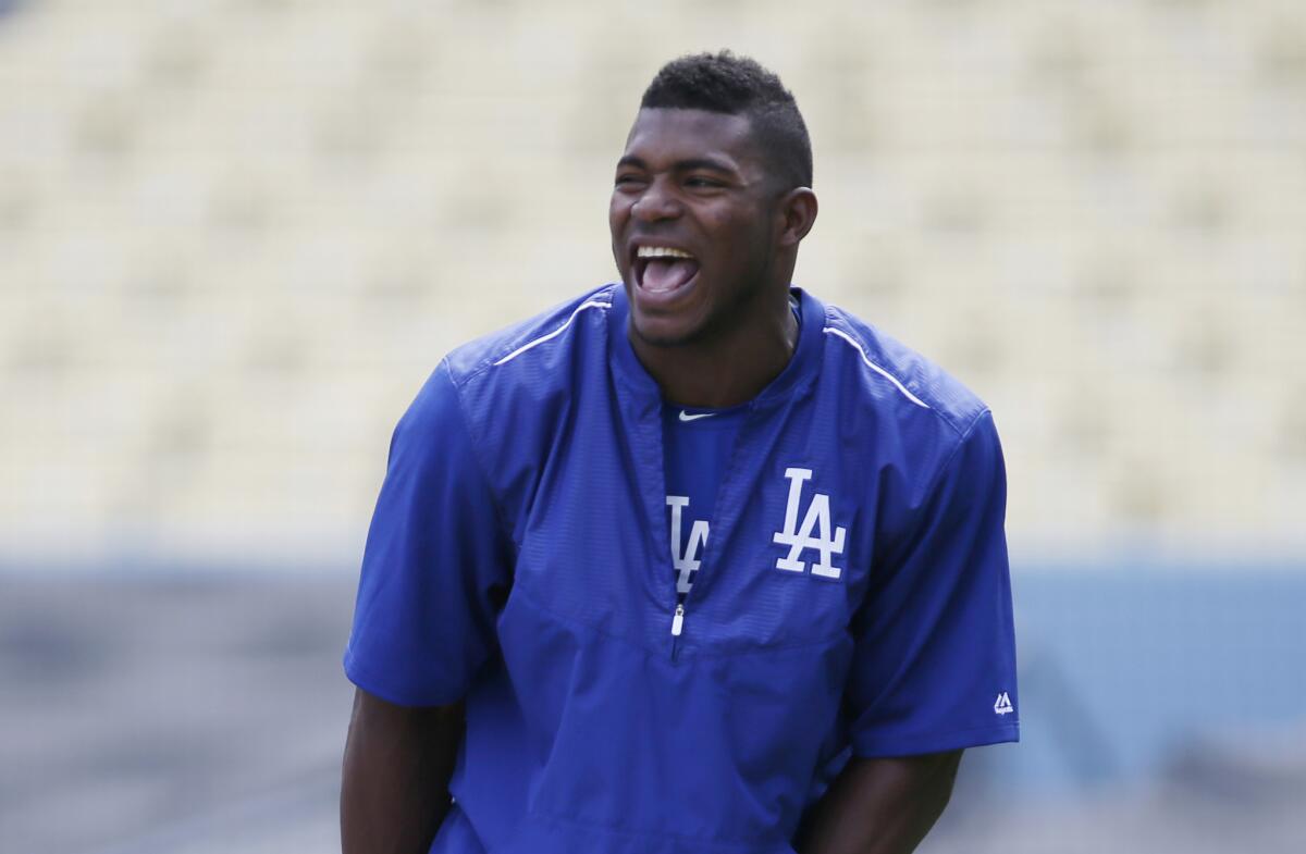 Dodgers outfielder Yasiel Puig laughs during a Tuesday practice for the upcoming NLDS against the Mets.