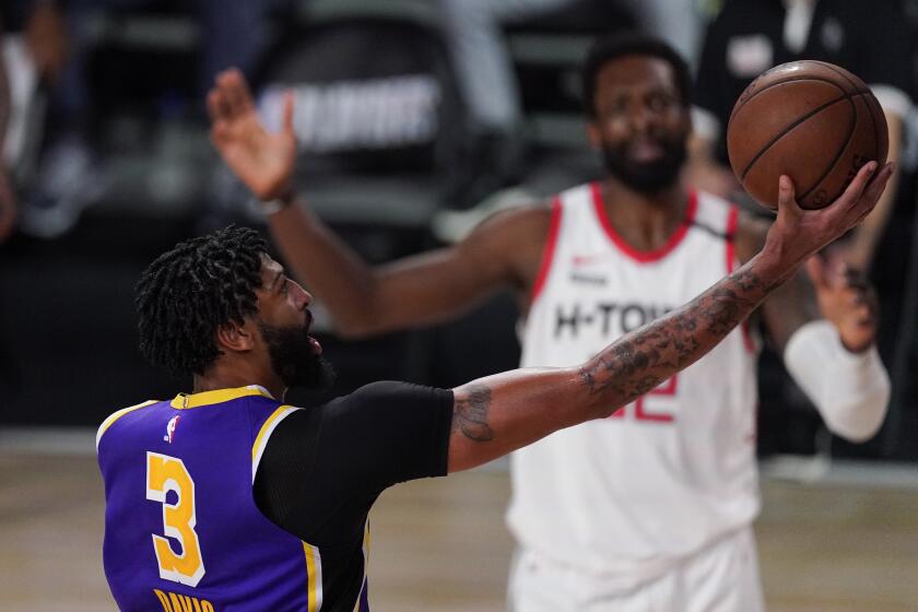 Los Angeles Lakers' Anthony Davis (3) drives to the basket ahead of Houston Rockets' Jeff Green, rear, during the second half of an NBA conference semifinal playoff basketball game Friday, Sept. 4, 2020, in Lake Buena Vista, Fla. (AP Photo/Mark J. Terrill)