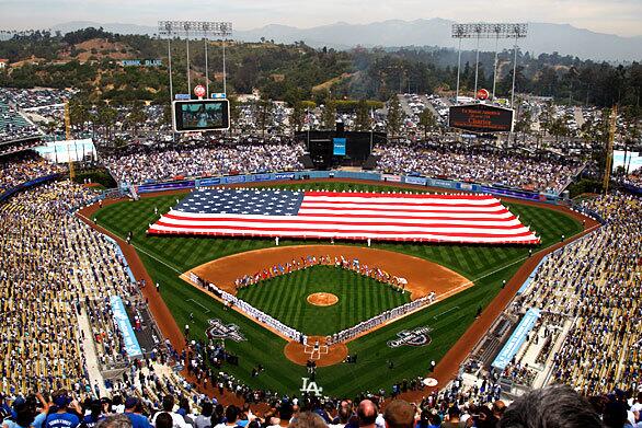 A giant American flag is unfurled across the outfield at Dodger Stadium before the home opener of the 2009 season. The Dodgers took on the San Francisco Giants.
