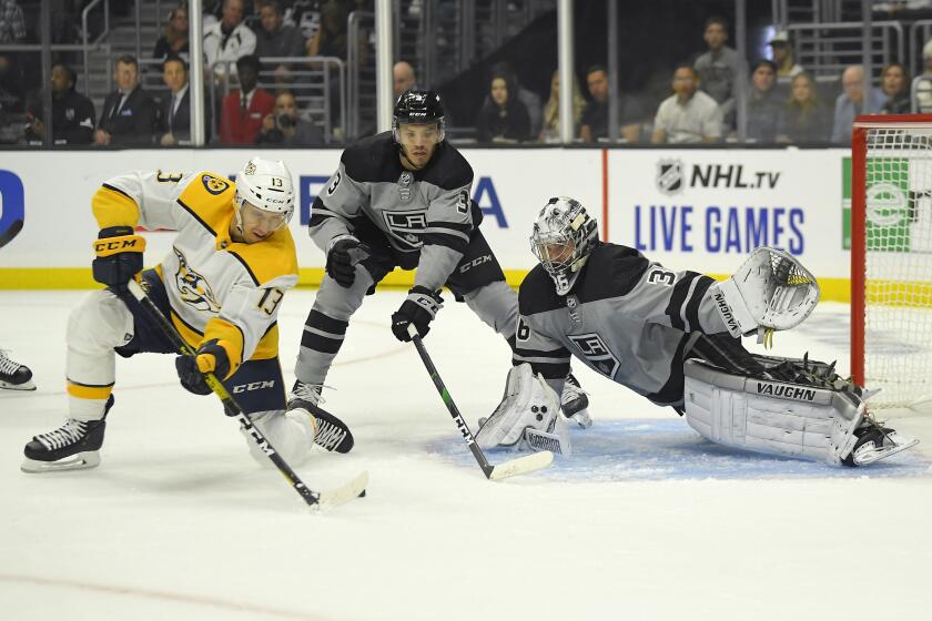 Nashville Predators center Nick Bonino, left, tries to get a shot past Los Angeles Kings goaltender Jack Campbell, right, whil defenseman Matt Roy helps defend during the first period of an NHL hockey game Saturday, Oct. 12, 2019, in Los Angeles. (AP Photo/Mark J. Terrill)