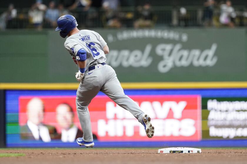 Los Angeles Dodgers' Will Smith rounds the bases after hitting a solo home run during the second inning of a baseball game against the Milwaukee Brewers, Tuesday, Aug. 13, 2024, in Milwaukee. (AP Photo/Aaron Gash)