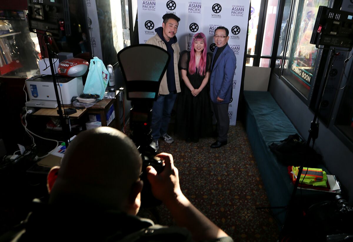 Filmmaker So Yun Um, center, poses for photos before the L.A. premiere