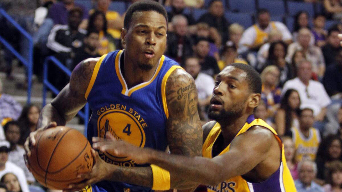 Golden State Warriors guard Brandon Rush (4) drives past Lakers guard Roscoe Smith during the second half of the Lakers' 116-75 preseason loss.