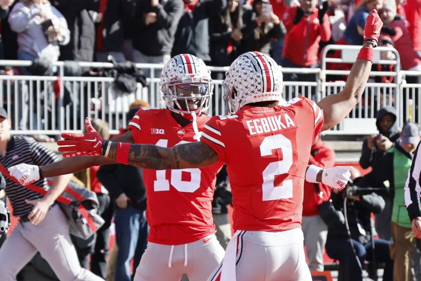 Ohio State receiver Marvin Harrison, left, celebrates his touchdown against Michigan with teammate Emeka Egbuka during the first half of an NCAA college football game on Saturday, Nov. 26, 2022, in Columbus, Ohio. (AP Photo/Jay LaPrete)