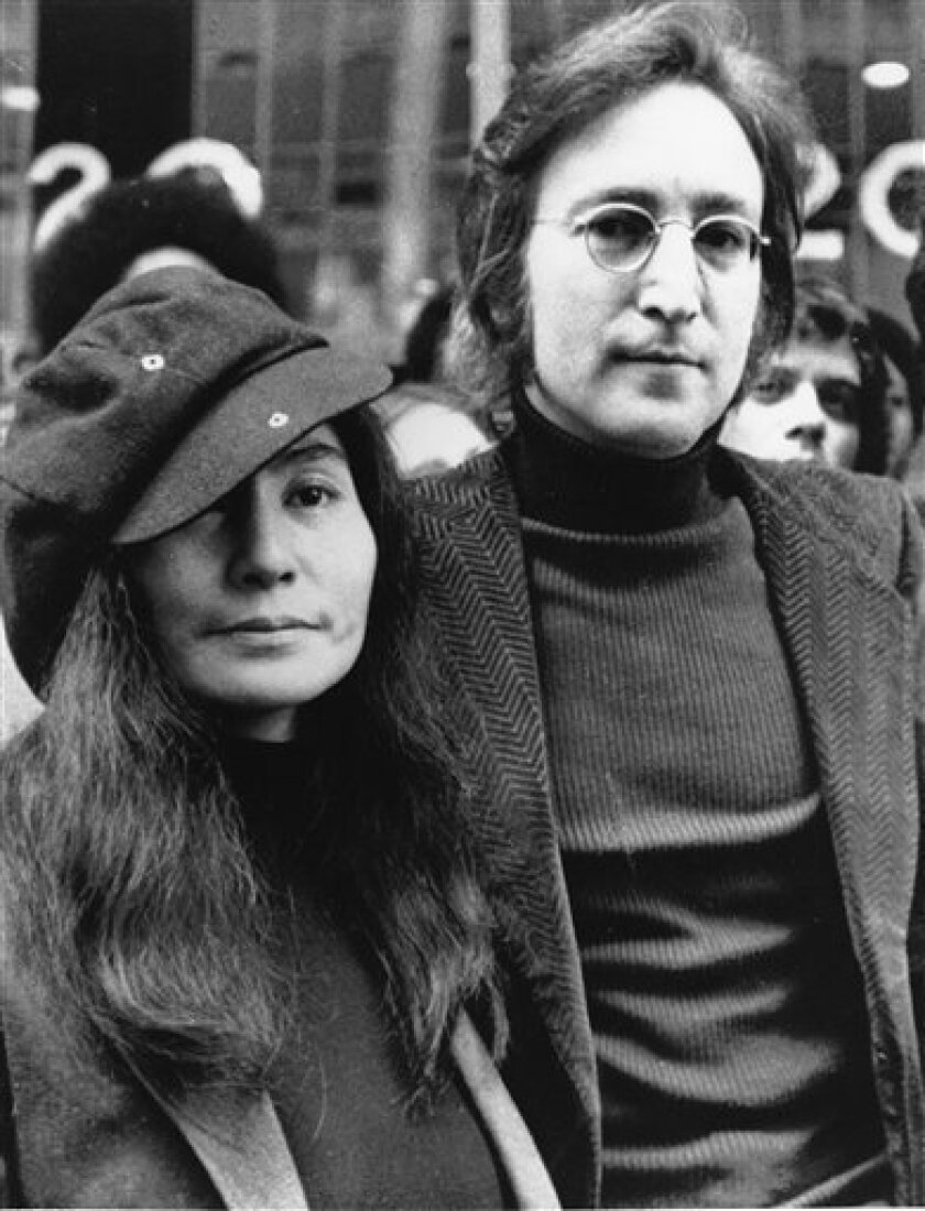 In this file photo dated April 18, 1972, John Lennon, right, and Yoko Ono, left, are seen outside the U.S. Immigration offices in New York City, USA. Vatican media praised the Beatles' musical legacy on Saturday, Nov. 22, 2008. John Lennon's boast that the British band was more popular than Jesus outraged many when he made it in 1966, Vatican newspaper L'Osservatore Romano noted, but that the remark can be written off now as the bragging of a young man wrestling with unexpected success. (AP Photo, File)