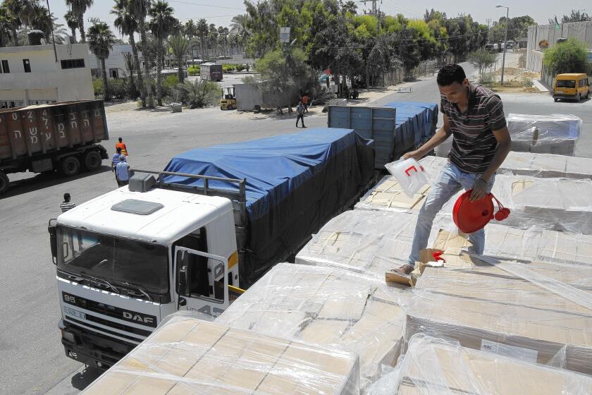 Trucks carrying humanitarian aid arrive in Rafah, in the Gaza Strip. Israelis and Palestinians were holding indirect talks in Cairo to try to extend a cease-fire.