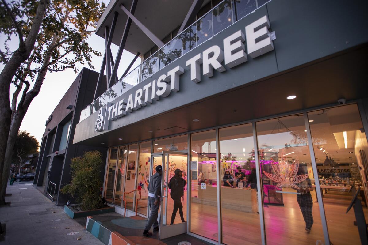 A twilight view of an exterior of the Artist Tree Dispensary & Weed Delivery West Hollywood.