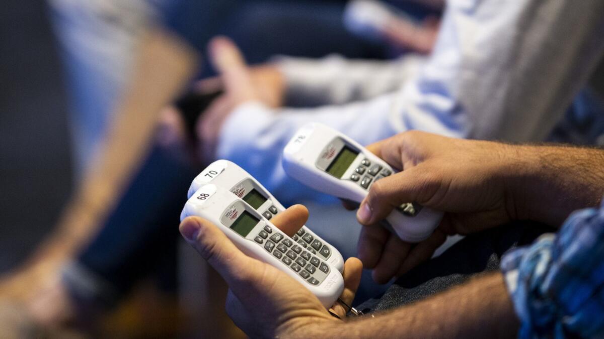 Delegates cast votes with electronic devices during the final day of the 2018 California Republican Party convention in San Diego.