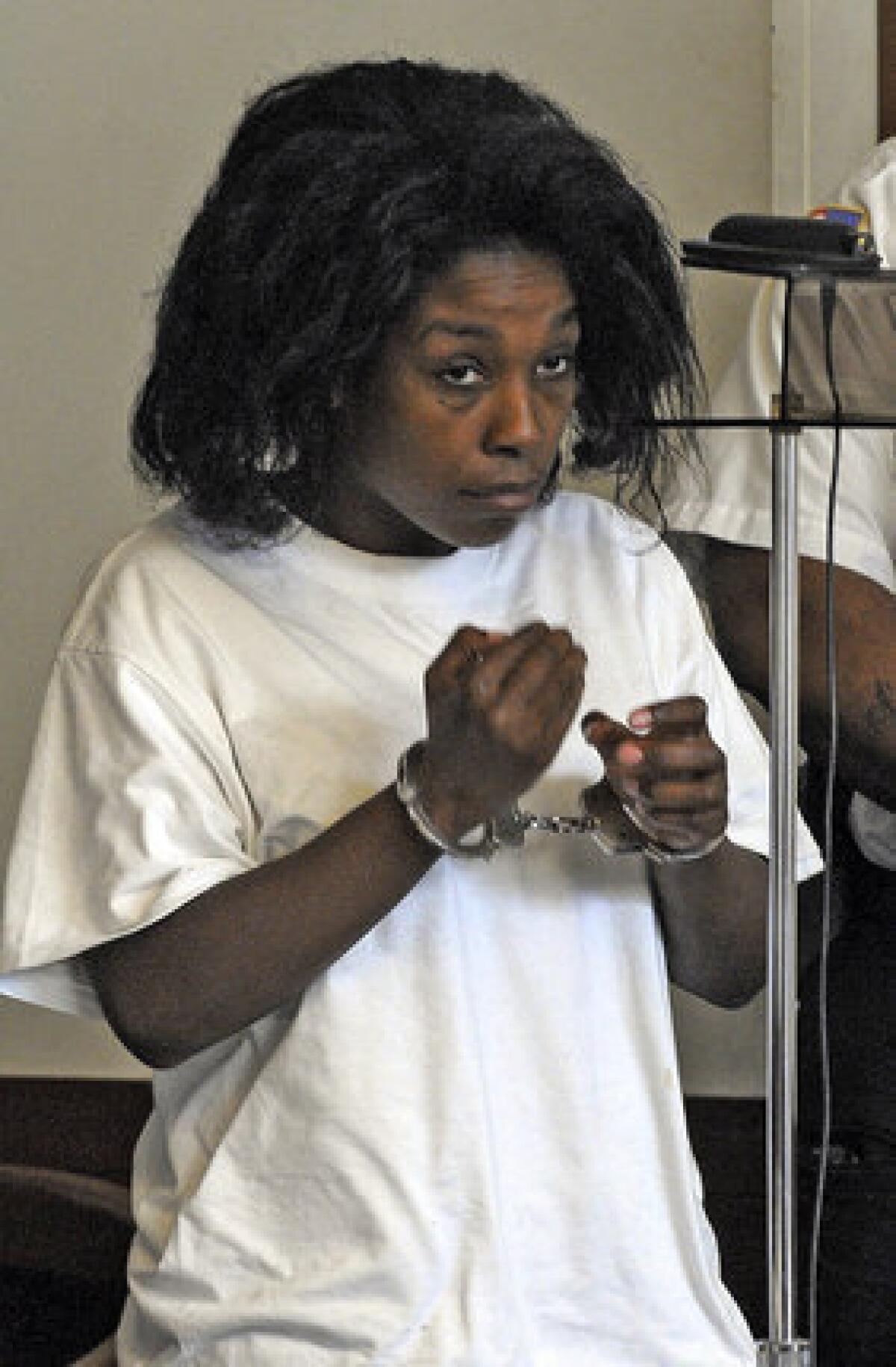 Audrea Gause, 26, of Troy, N.Y., stands during her arraignment Friday, Aug. 2, 2013, in Boston Municipal Court. Gause was charged with filing a false claim for nearly $500,000 with The One Fund Boston, set up to aid Boston Marathon bombing victims.