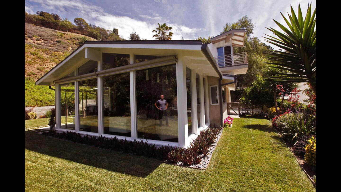 Architect Todd Conversano is reflected in a window of his home north of Beverly Hills.