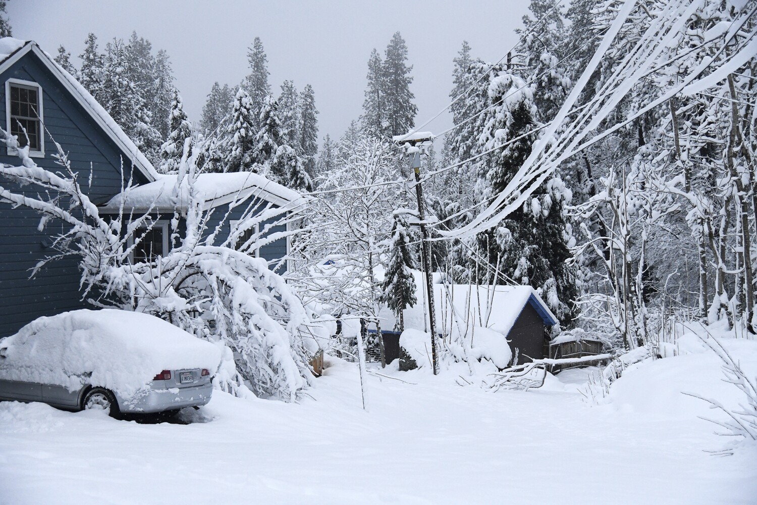 Record-breaking Sierra snow buries towns, closes highways