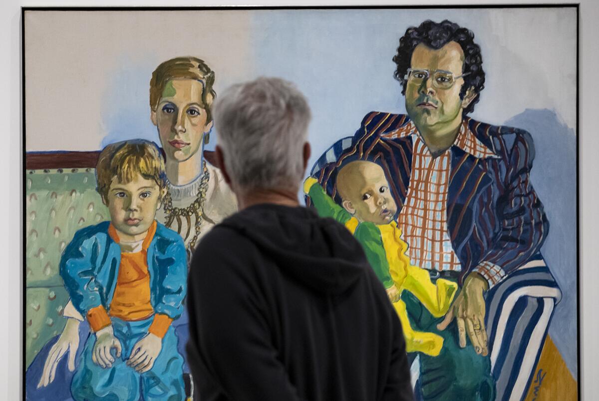  A guest looks at a piece by Alice Neel during a preview of Orange County Museum of Art's new summer exhibitions.