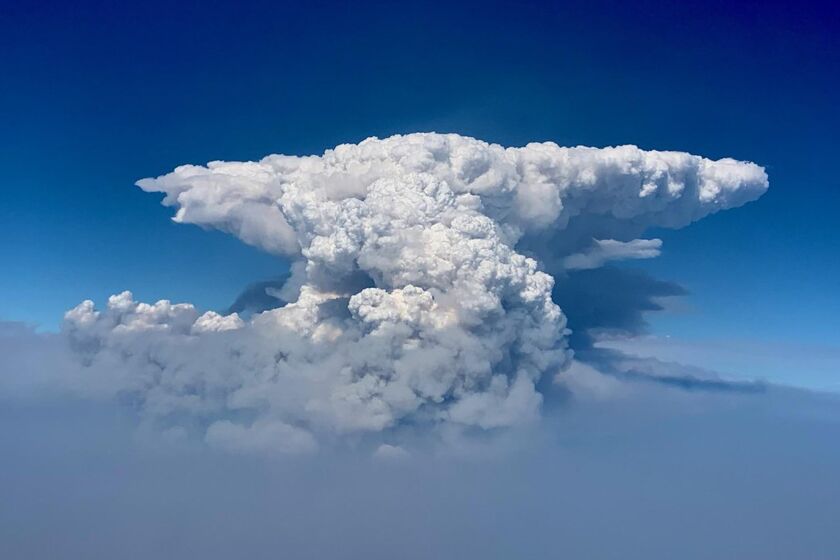 In this photo taken with a drone provided by the Bootleg Fire Incident Command, a pyrocumulus cloud, also known as a fire cloud, is seen over the Bootleg Fire in southern Oregon on Wednesday, July 14, 2021. Smoke and heat from a massive wildfire in southeastern Oregon are creating "fire clouds" over the blaze — dangerous columns of smoke and ash that can reach up to 30,000 feet (9,144 meters) and are visible for more than 100 miles (160 kilometers) away. Authorities have put these clouds at the top of the list of the extreme fire behavior they are seeing on the Bootleg Fire, the largest wildfire burning in the U.S. (Bootleg Fire Incident Command via AP)