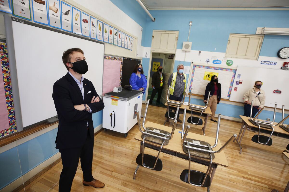 School officials check out empty classroom for reopening.