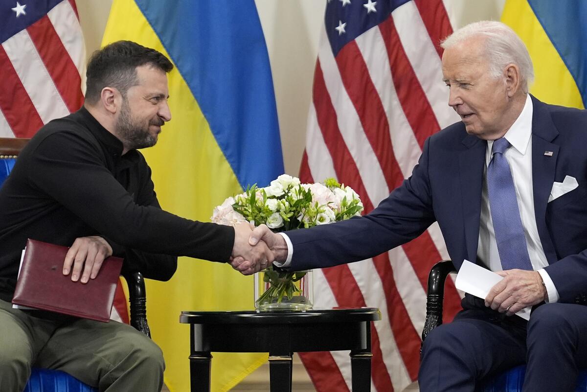 President Biden shakes hands with Ukrainian President Volodymyr Zelensky