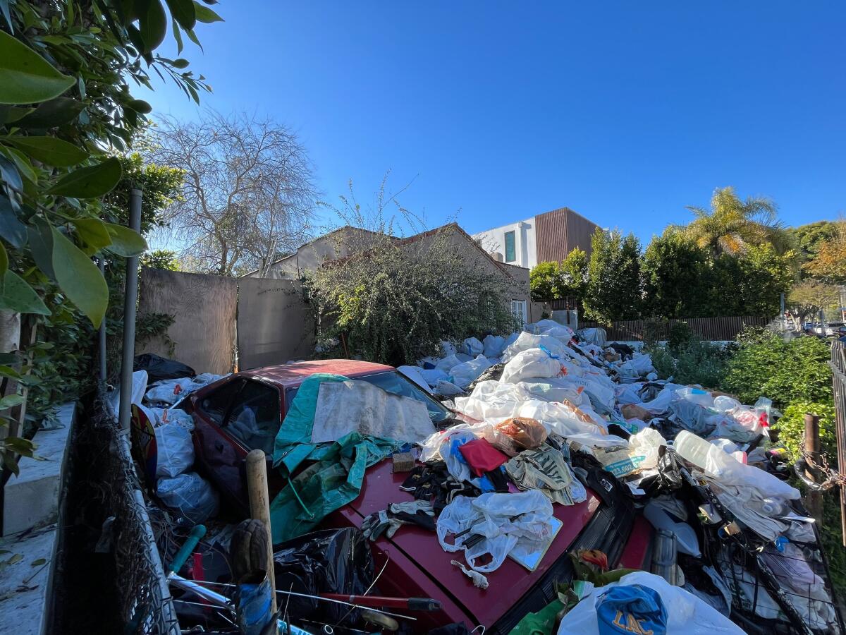 A trash-covered home in L.A. draws outrage, worry and a ‘Hoarders’ producer
