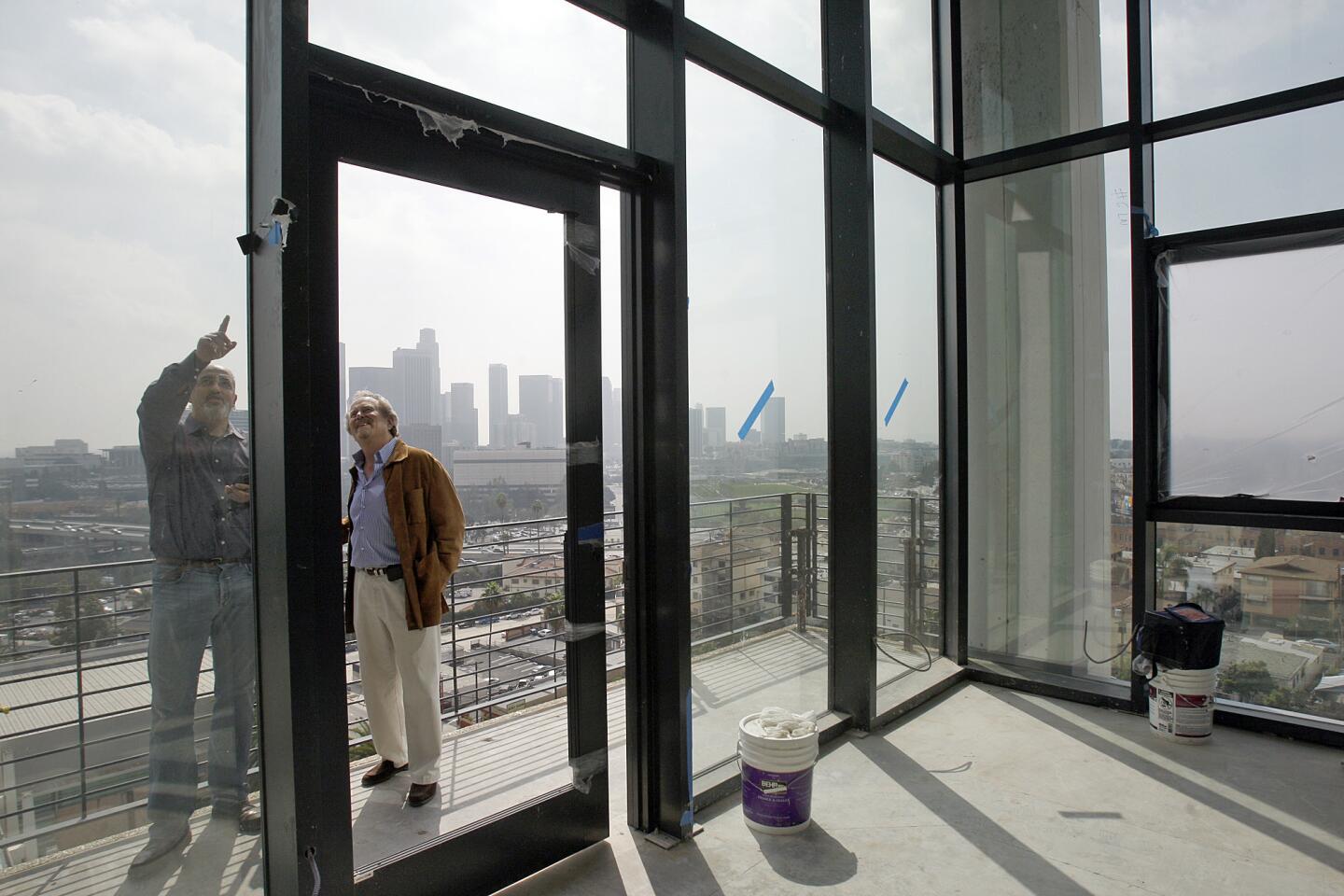 Linear City Development's Leonard Hill, right, and Yuval Bar-Zemer view one of the Elysian's penthouse apartments. The 14 high-ceiling penthouses will rent for up to $6,500 a month.