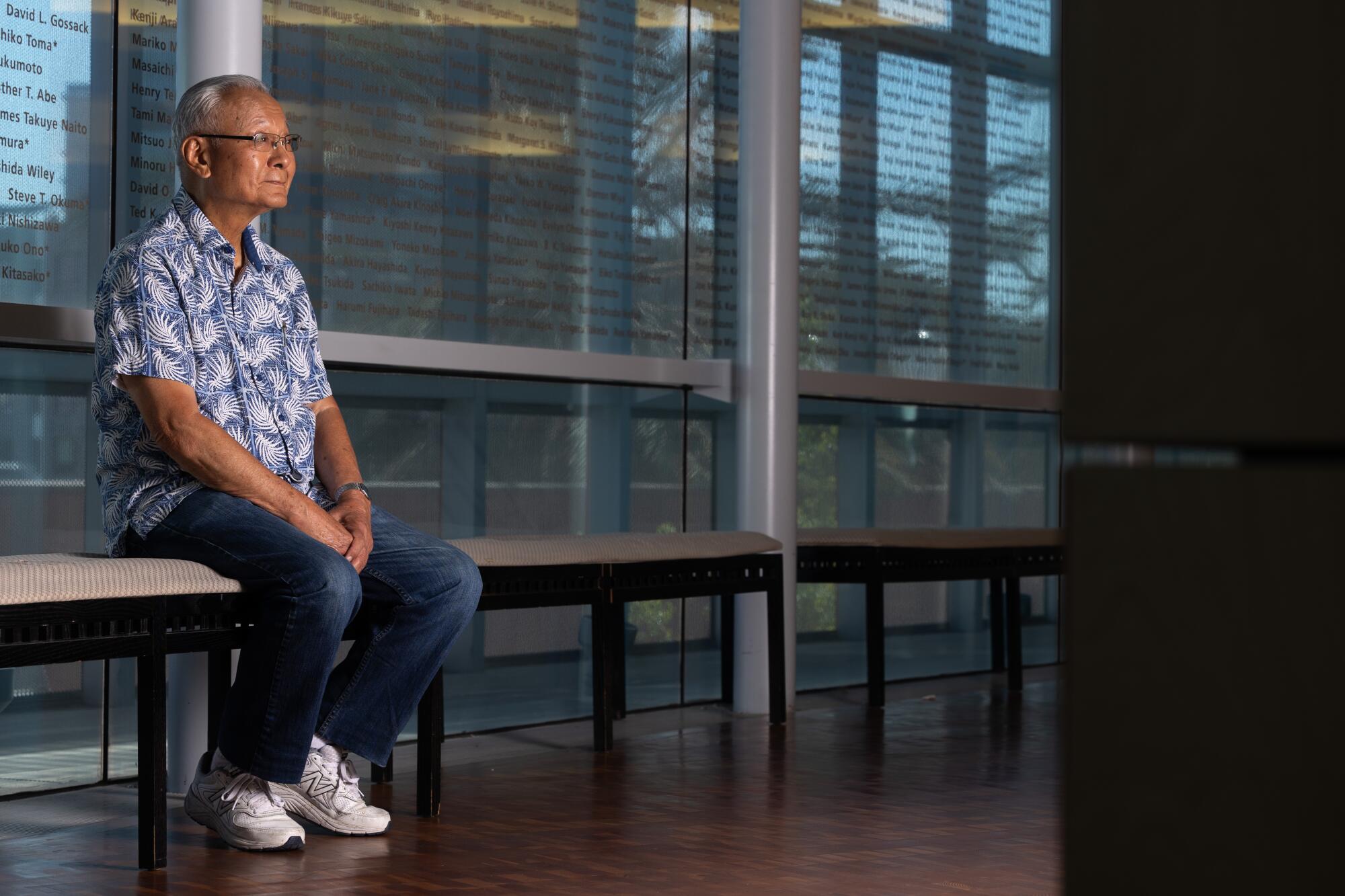 Bill Watanabe sits on a bench in the Japanese American National Museum in Little Tokyo.