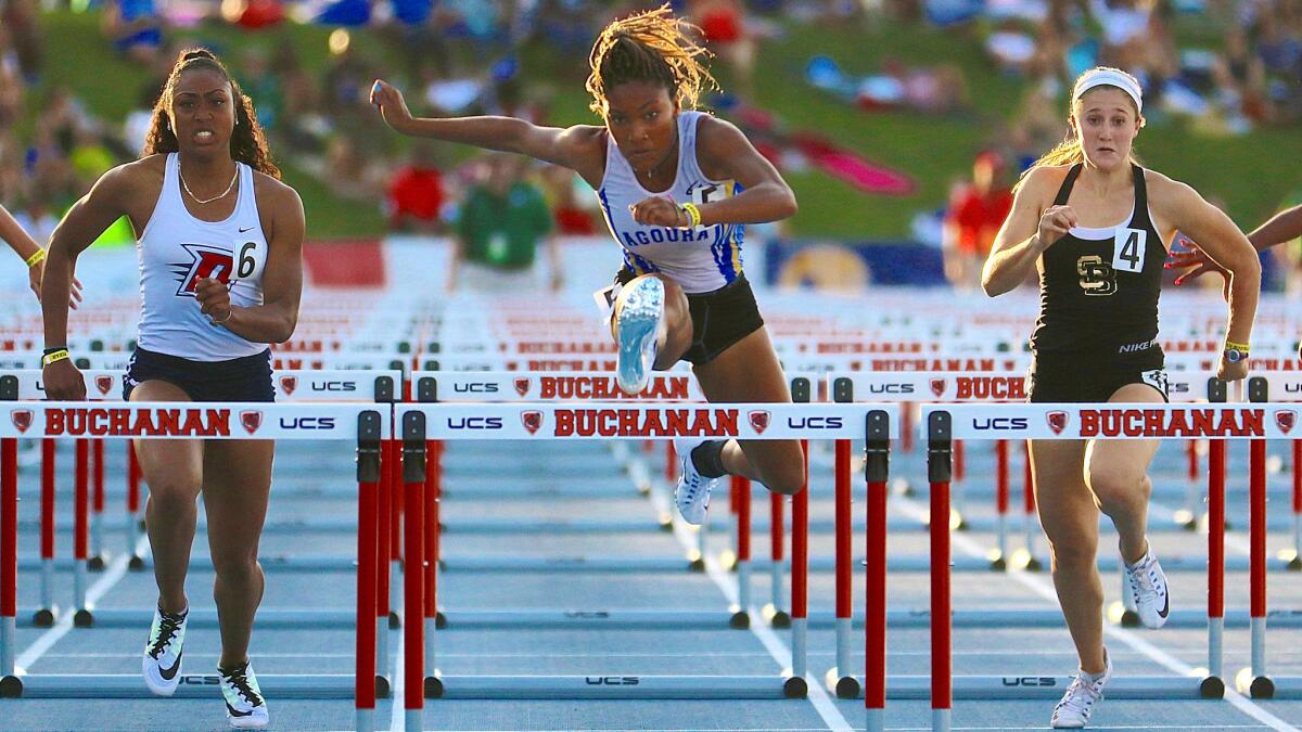 Agoura's Tara Davis (center) clocked the fastest qualifying time in the 100 hurdles in 13.50 seconds on Friday.