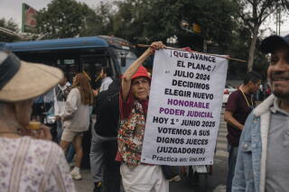 Supporters carry signs to promote voting during a rally