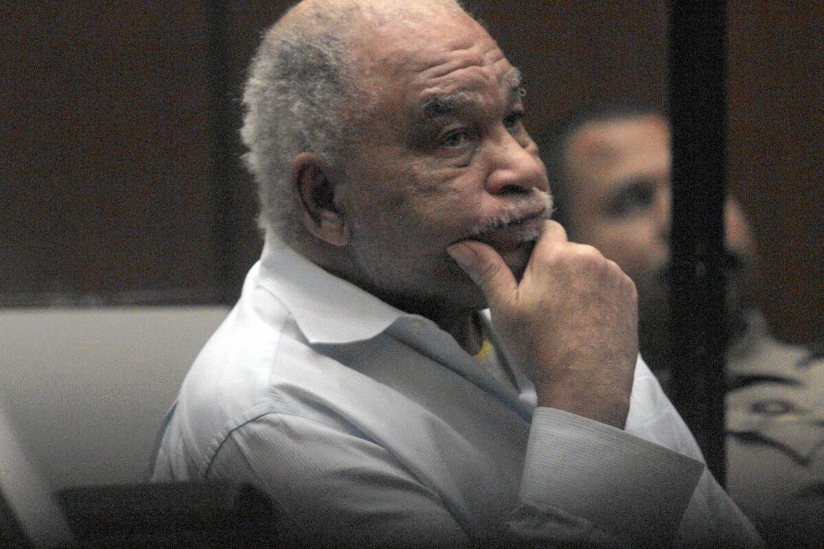 Samuel Little sits in court with his hand on his chin