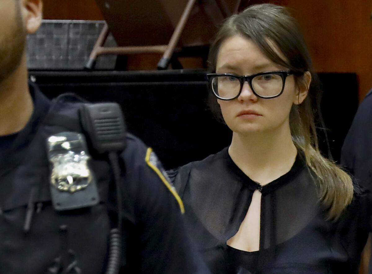 FILE - In this Thursday April 4, 2019, file photo Anna Sorokin is escorted into a courtroom after a recess in her trial at New York State Supreme Court in New York. U.S. immigration authorities said Thursday, April 1, 2021, they have detained Sorokin, who passed herself off as a wealthy German heiress and served three years behind bars for defrauding New York banks and hotels. Sorokin has been in immigration custody since late March. (AP Photo/Richard Drew, File)