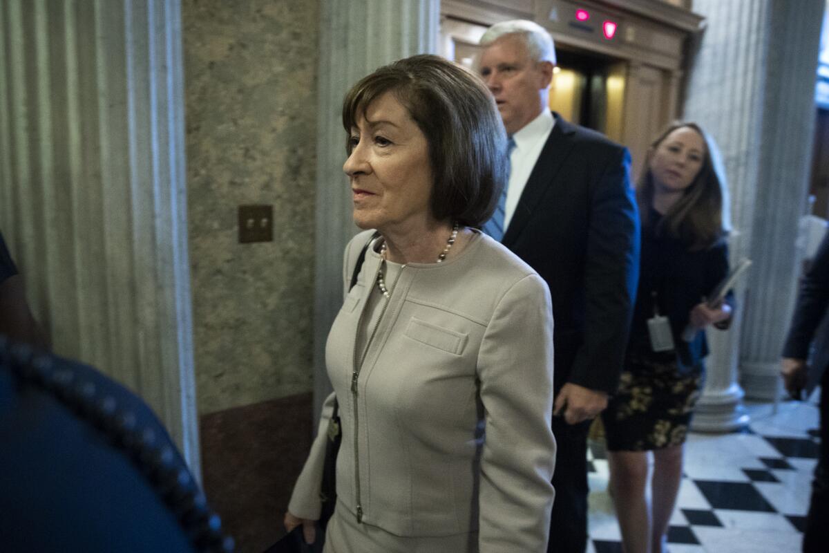 Sen. Susan Collins (R-Maine) walks to the Senate floor on Friday.